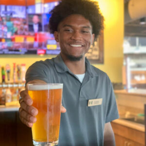 harvest market employee serving draft beer